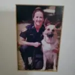 A picture of a police officer and her dog.